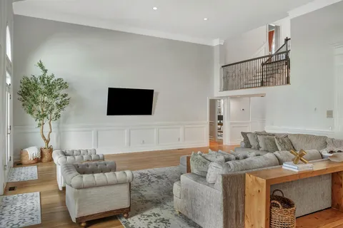 a living room with furniture and a wooden floor