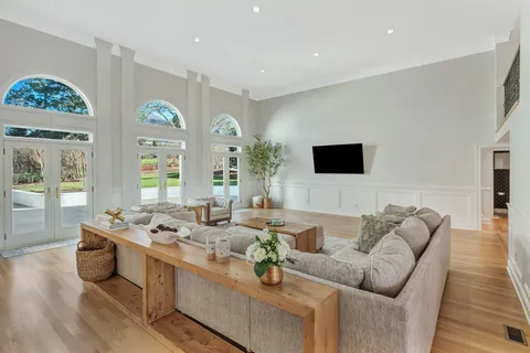 a view of a house with a yard and hanging chair