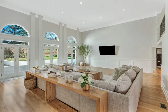 a view of a house with a yard and hanging chair