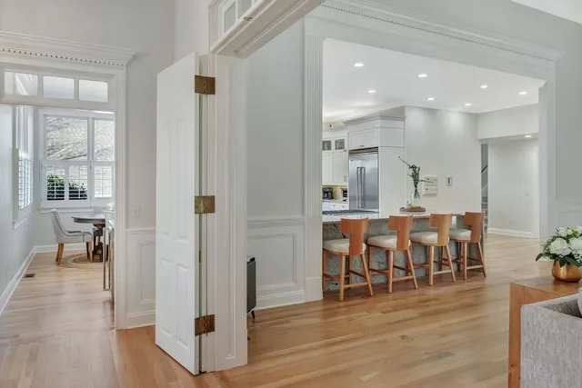 a bedroom with a bed and a flat tv screen on wall