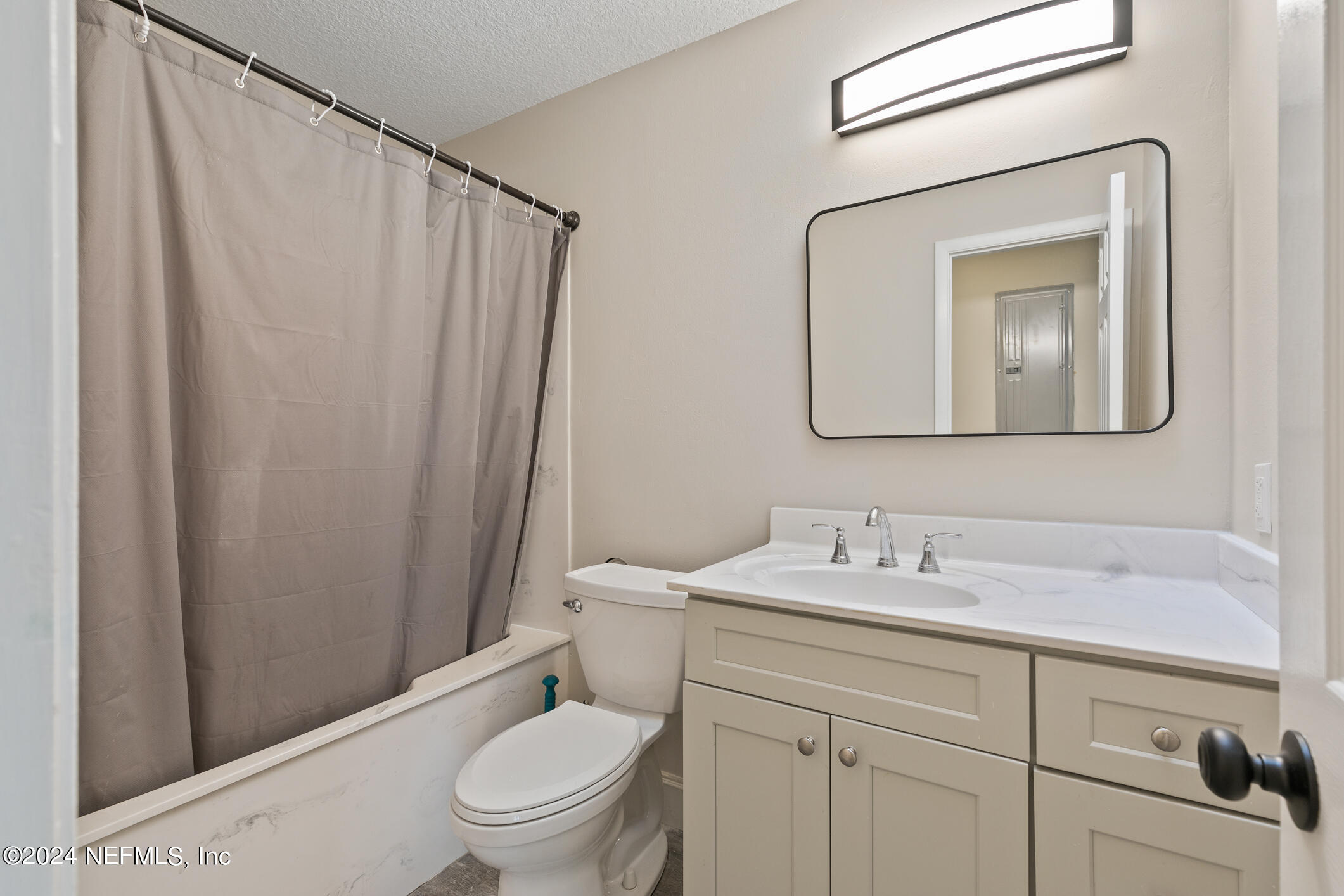 5984 Chevy Drive Jacksonville, FL 32216 - Photo 19 of 28 a bathroom with a toilet a sink and a mirror