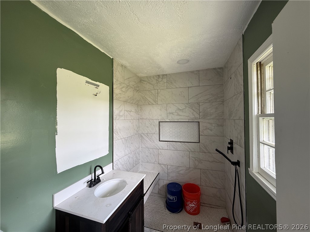 736 Tobermory Road Fayetteville, NC 28306 - Photo 8 of 17 a bathroom with a sink and a mirror