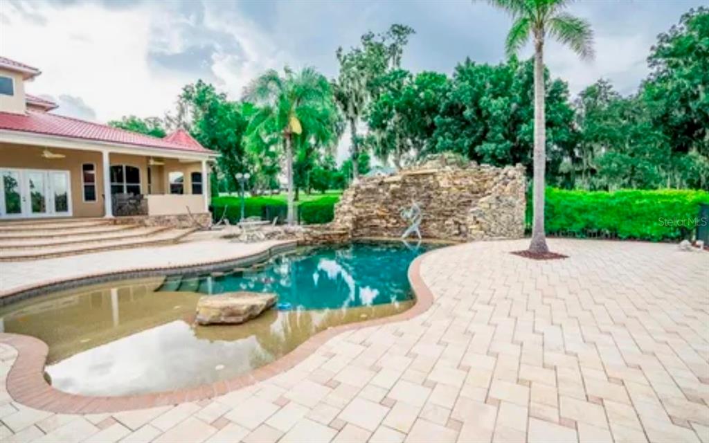 11715 Taylor Road Thonotosassa, FL 33592 - Photo 10 of 21 a view of a white house with a yard patio and swimming pool