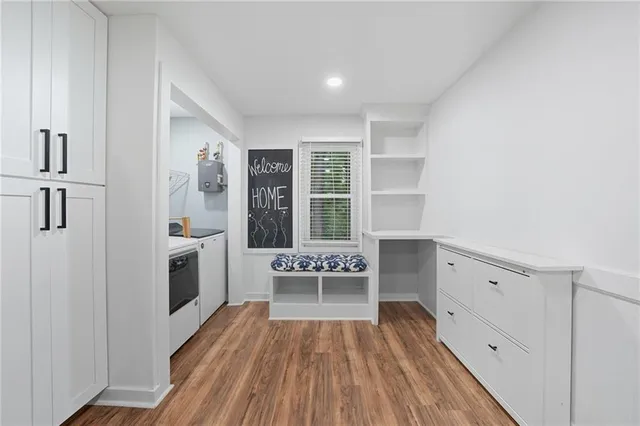 a view of workspace with wooden floor and windows