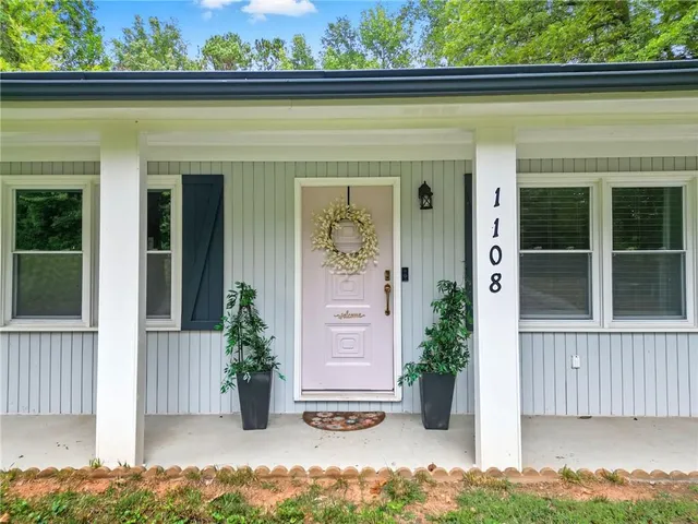 front view of a house with potted plants