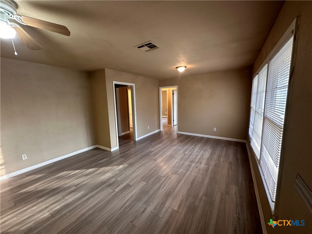 505 Center Street Belton, TX 76513 - Photo 4 of 11 a view of an empty room with wooden floor and a window