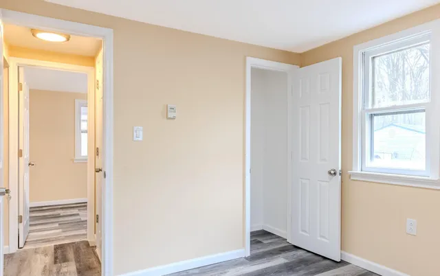 a view of an entryway with wooden floor