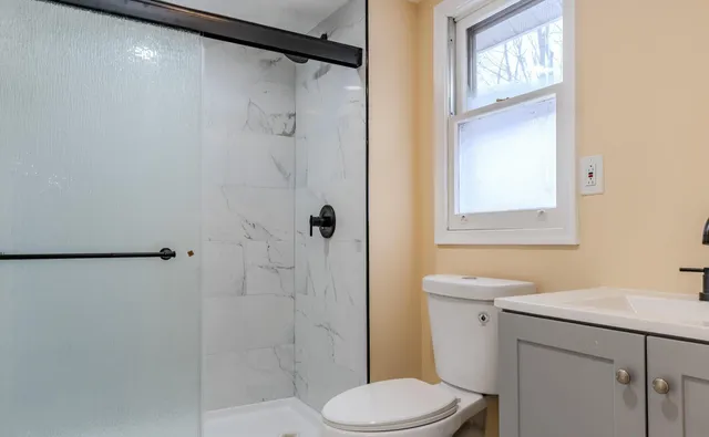 a bathroom with a sink toilet and shower