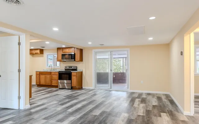 a view of kitchen with sink and wooden floor
