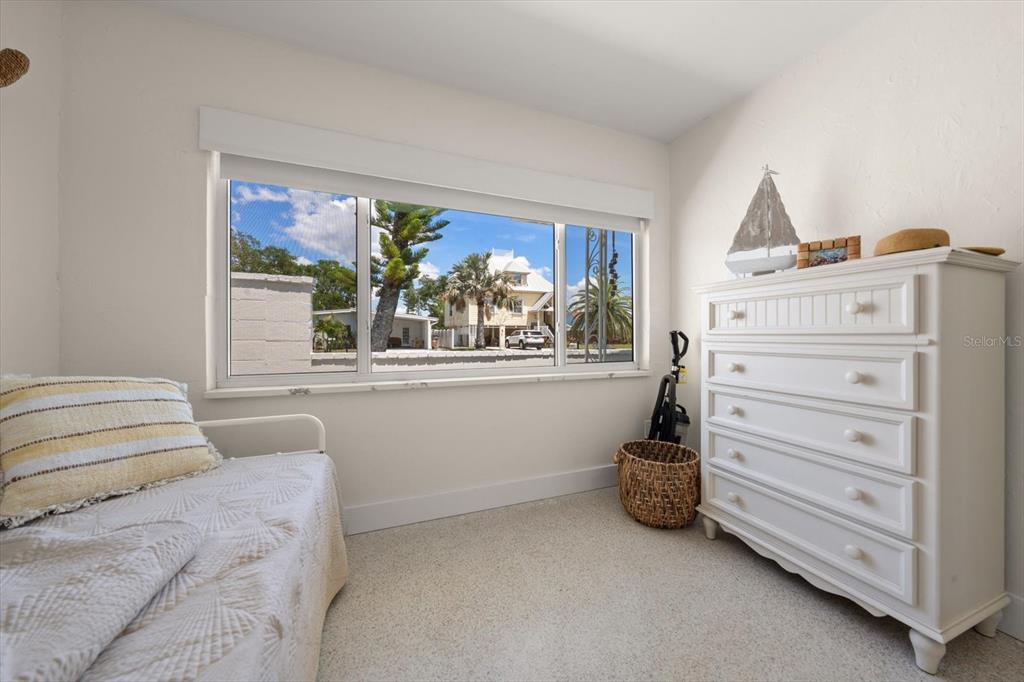 127 11th Avenue Indian Rocks Beach, FL 33785 - Photo 18 of 63 a bedroom with a bed and a window