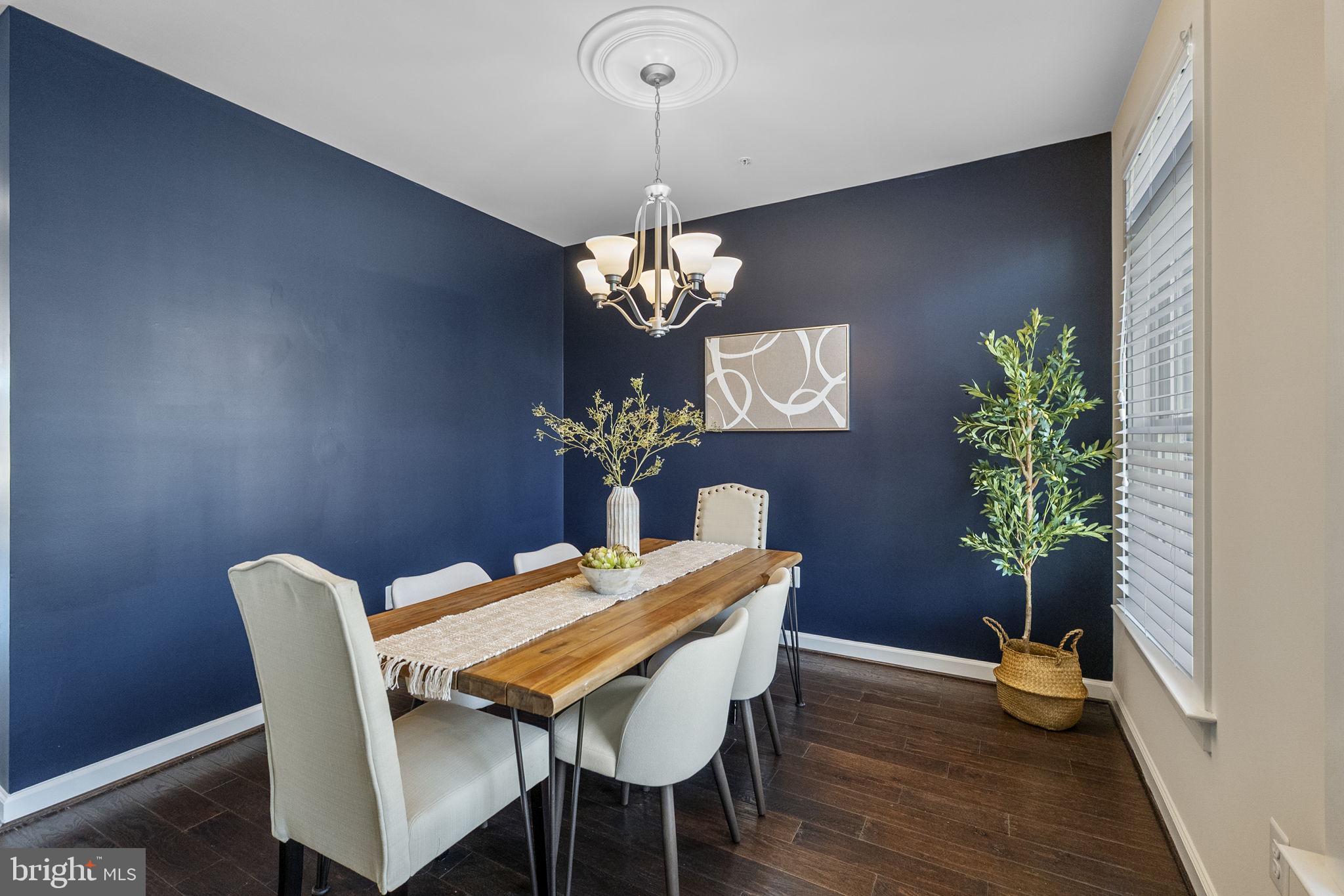 5313 Stream Bank Lane Greenbelt, MD 20770 - Photo 10 of 46 a dining room with furniture potted plants and wooden floor