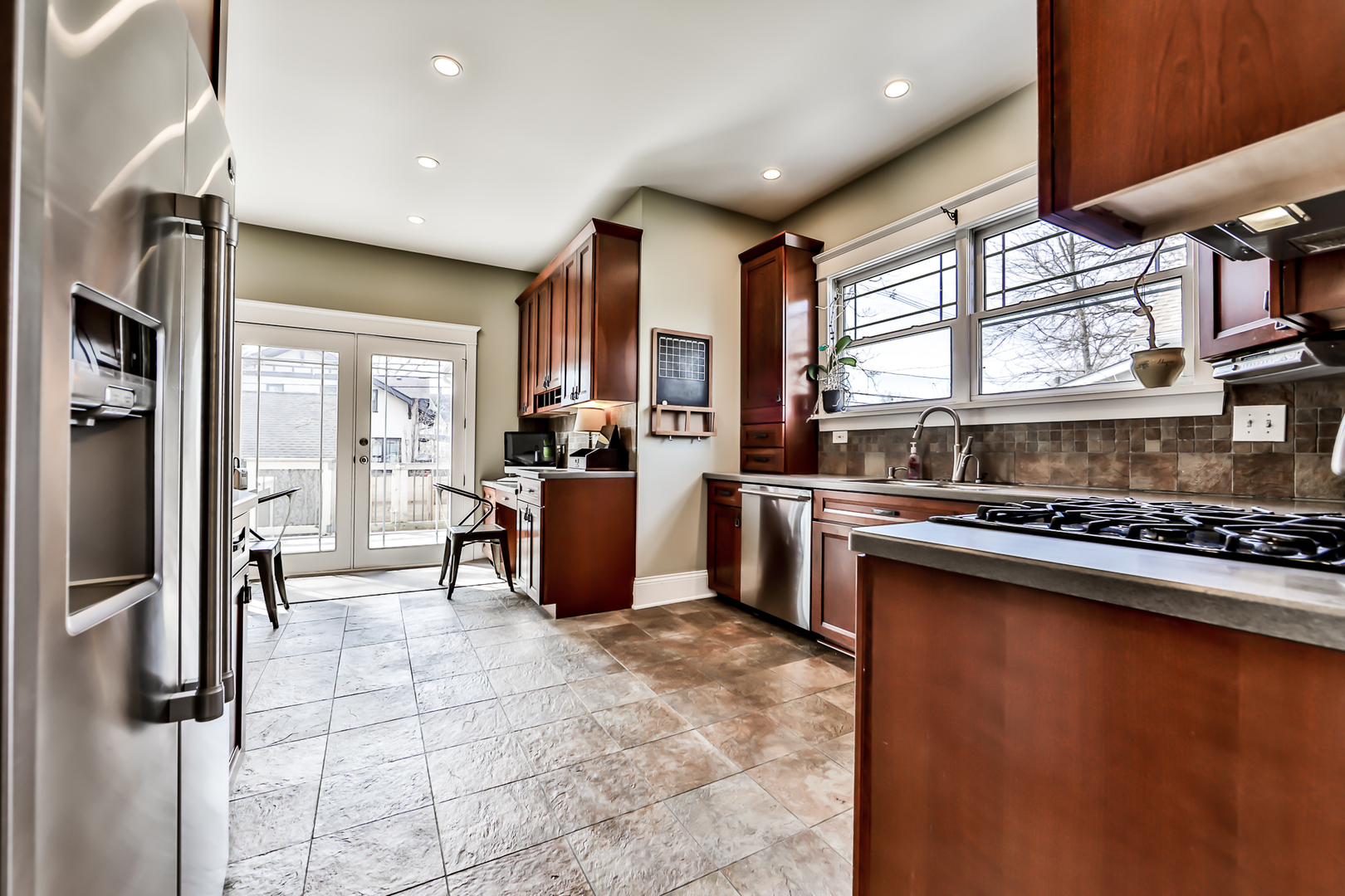 65 East Quincy Street Riverside, IL 60546 - Photo 13 of 49 a kitchen with stainless steel appliances granite countertop a sink stove and refrigerator