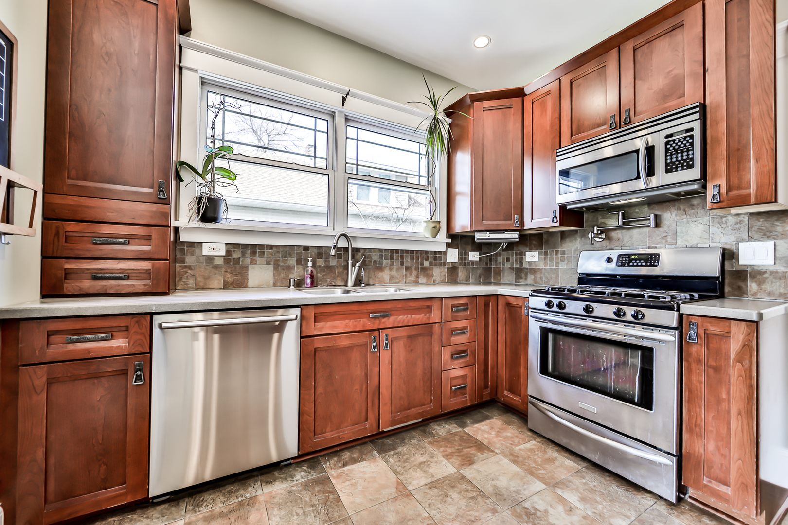 65 East Quincy Street Riverside, IL 60546 - Photo 15 of 49 a kitchen with stainless steel appliances granite countertop a stove sink and microwave