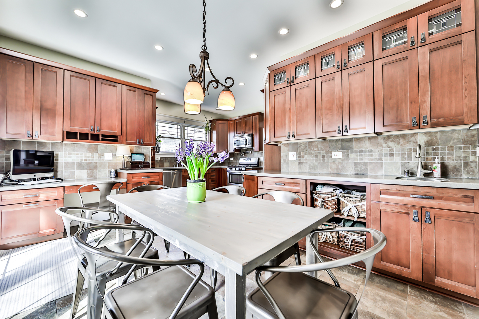 65 East Quincy Street Riverside, IL 60546 - Photo 17 of 49 a kitchen with a dining table chairs stainless steel appliances and cabinets