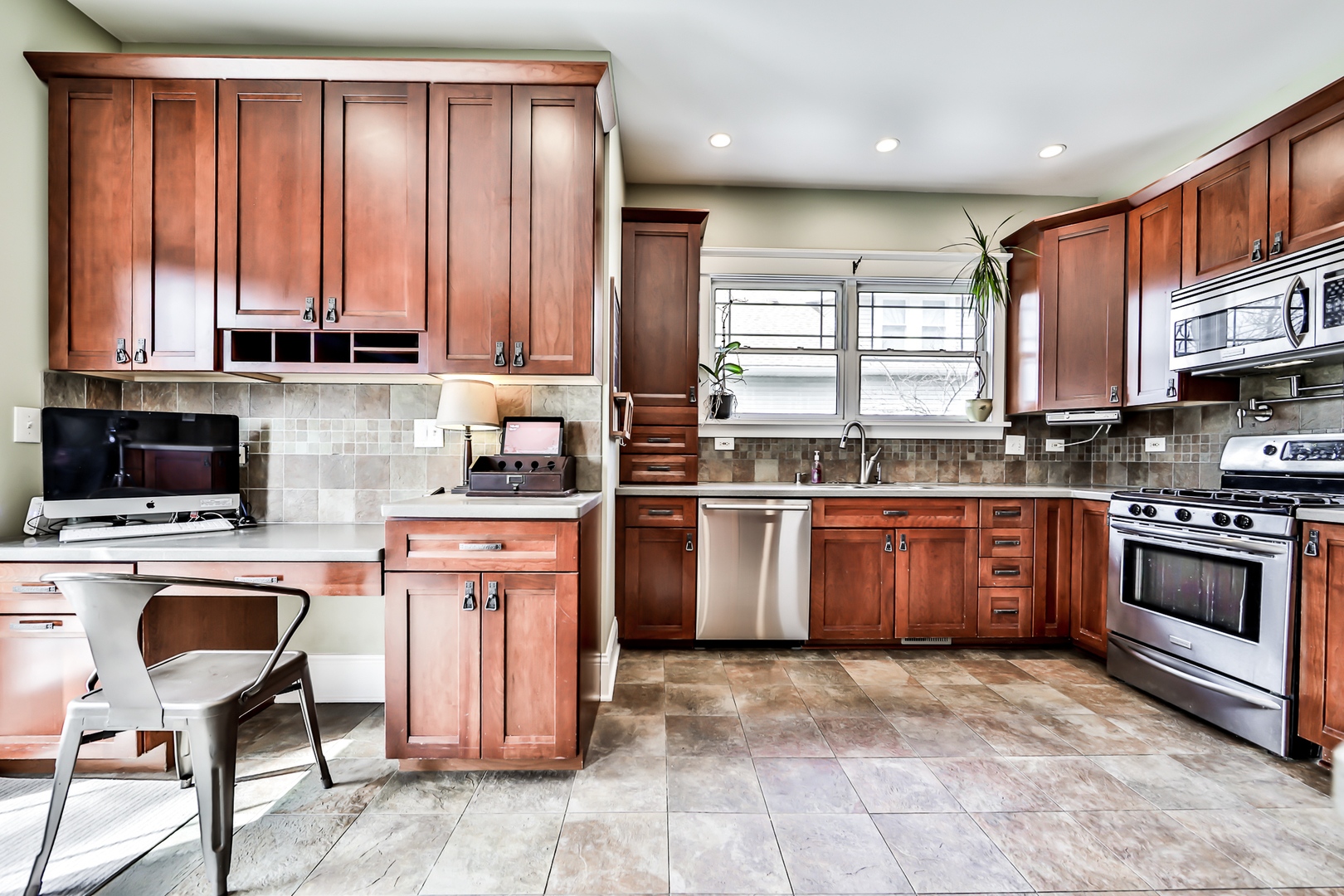 65 East Quincy Street Riverside, IL 60546 - Photo 18 of 49 a kitchen with stainless steel appliances granite countertop a stove a sink dishwasher a refrigerator and cabinets with wooden floor