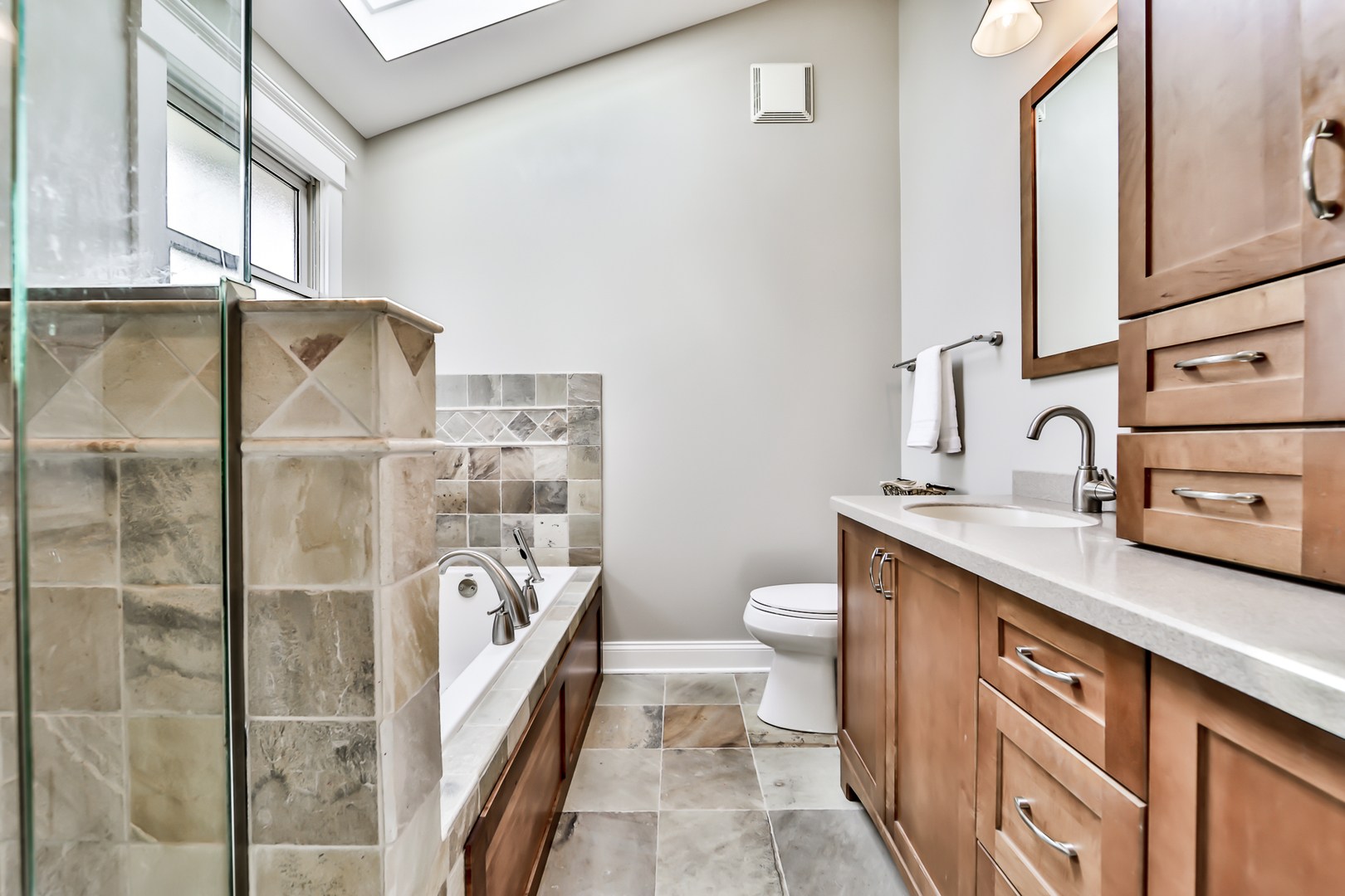 65 East Quincy Street Riverside, IL 60546 - Photo 23 of 49 a bathroom with a sink a toilet and shower