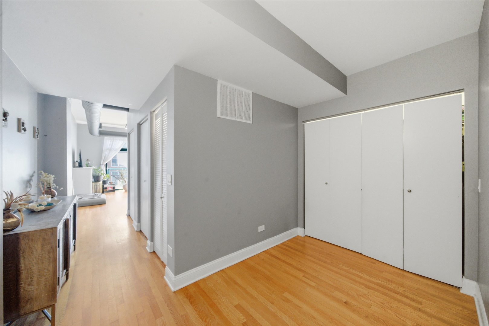 910 West Madison Street, Unit 803 Chicago, IL 60607 - Photo 3 of 15 a view of a room with wooden floor and furniture