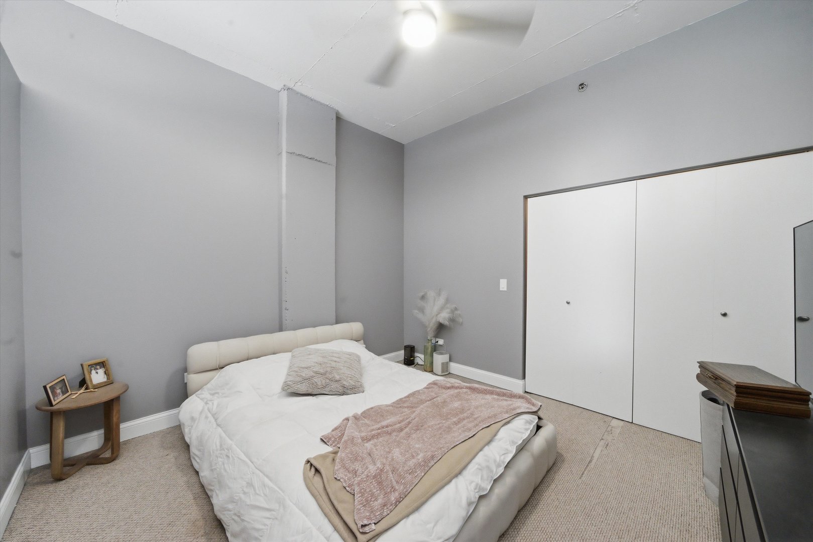 910 West Madison Street, Unit 803 Chicago, IL 60607 - Photo 9 of 15 a bedroom with a bed and a chandelier