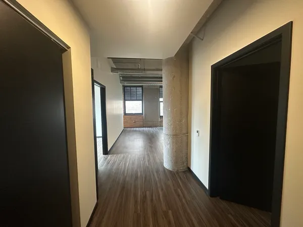 a view of a hallway with wooden floor