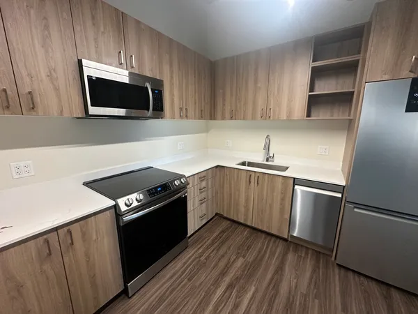 a kitchen with a sink and a stove top oven
