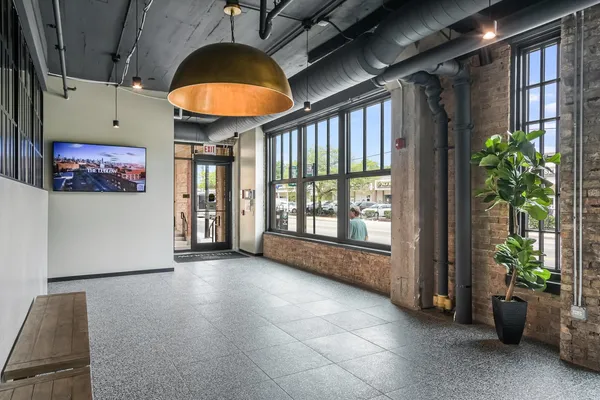 a living room with furniture and a floor to ceiling window