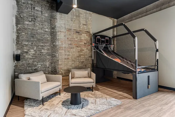 a view of a room with gym equipment and wooden floor
