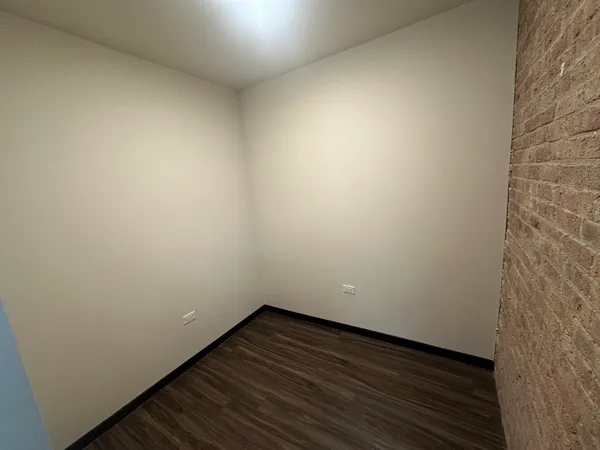 a view of an empty room and wooden floor