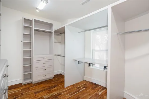 walk in closet with wooden floor