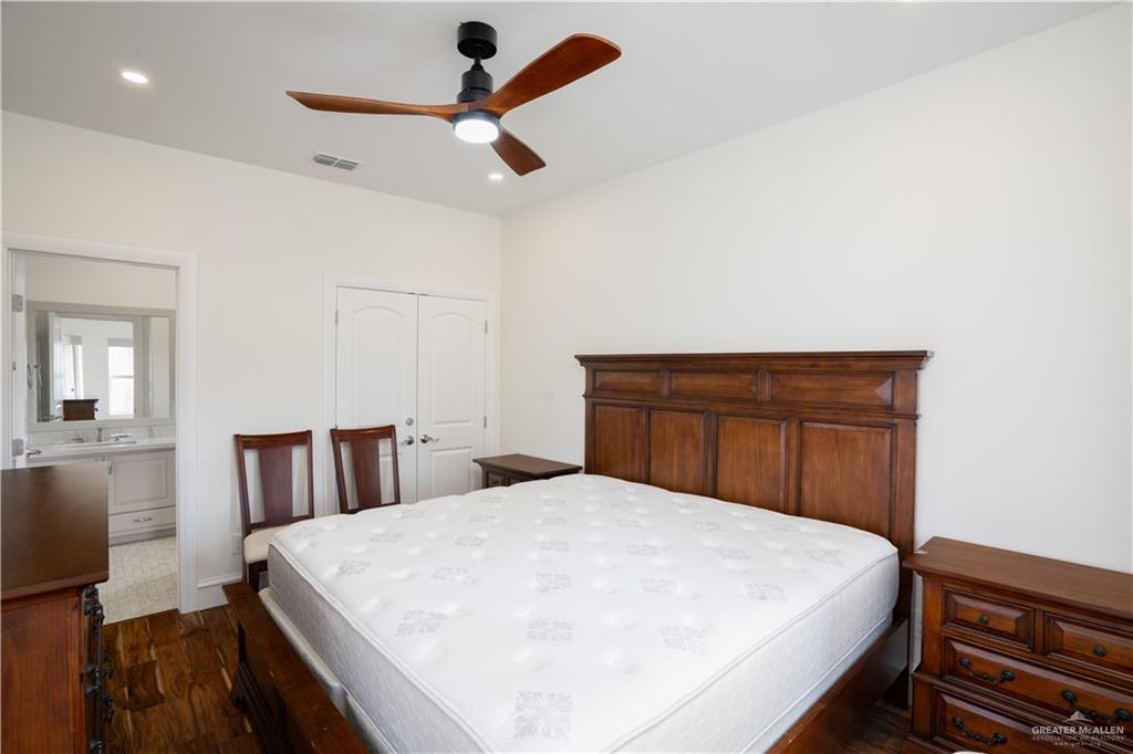 2013 Sabinal Street Mission, TX 78572 - Photo 21 of 33 a bedroom with a large bed and a ceiling fan