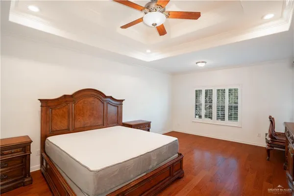 a bedroom with a large bed and a chandelier