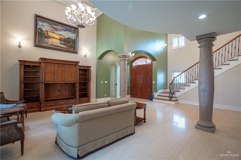 2013 Sabinal Street Mission, TX 78572 - Photo 7 of 33 a living room with furniture a dining table and a chandelier