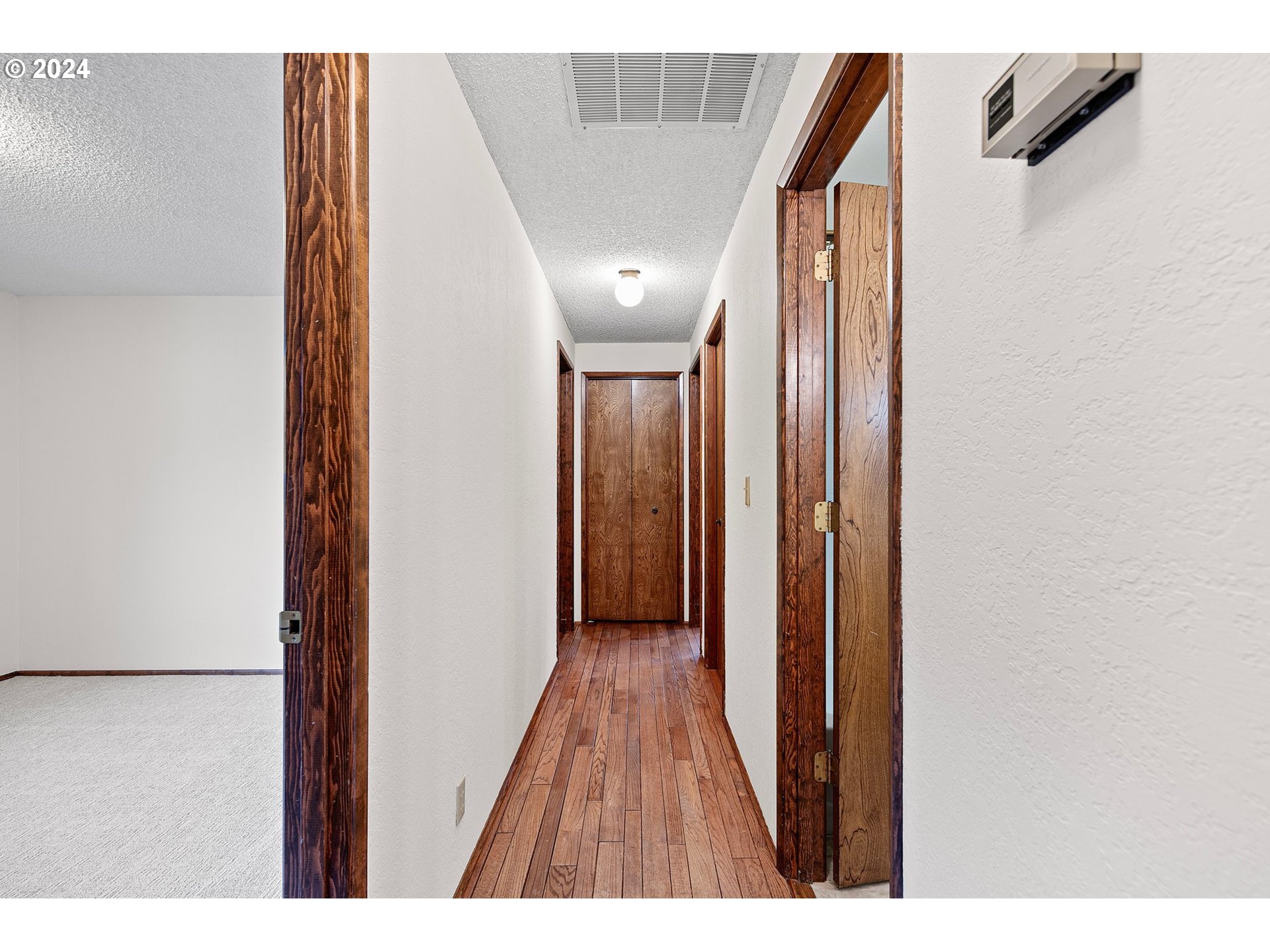 609 Rowan Avenue Springfield, OR 97477 - Photo 18 of 32 a view of a hallway with wooden floor