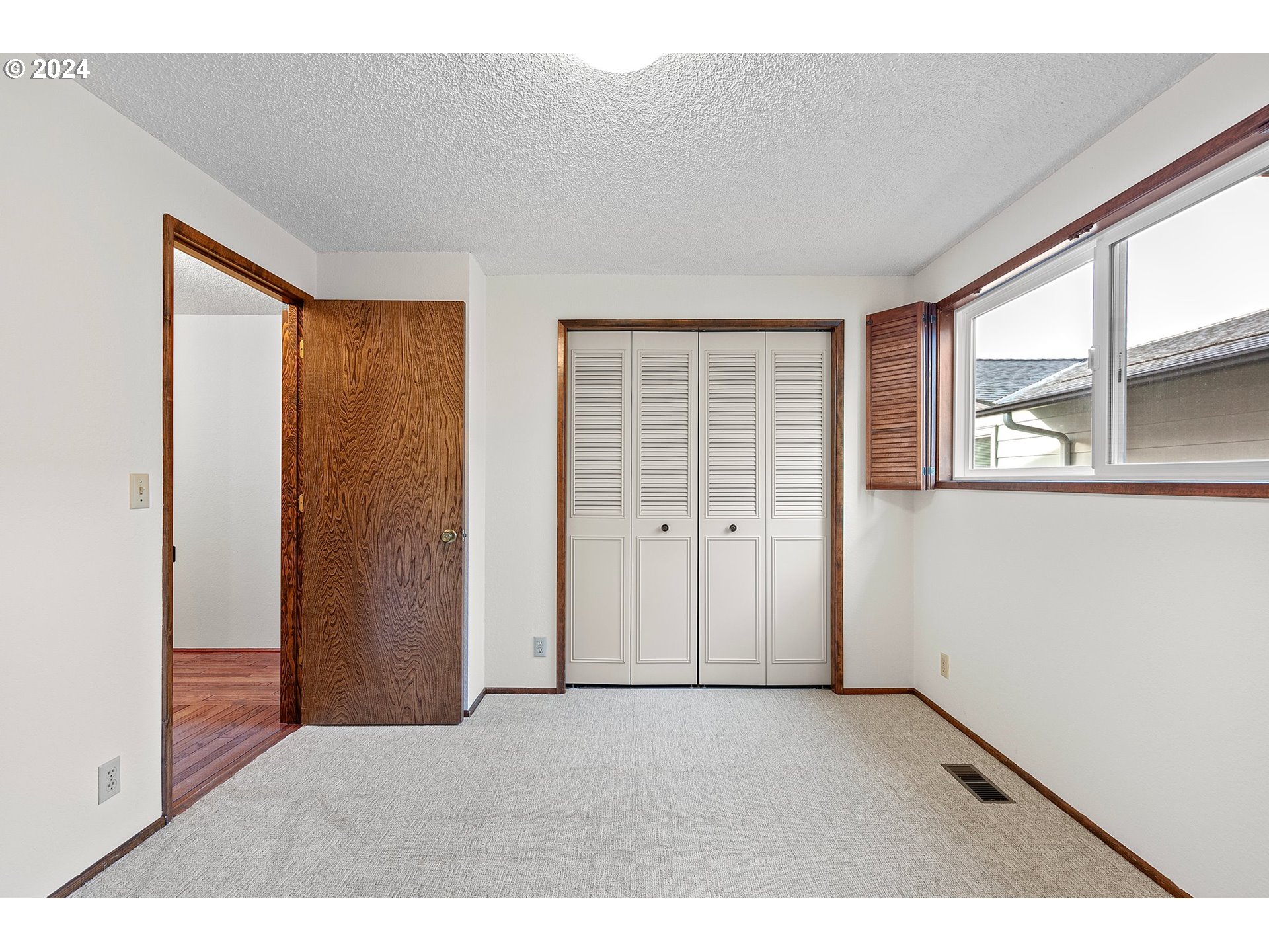 609 Rowan Avenue Springfield, OR 97477 - Photo 21 of 32 a view of an empty room with a window