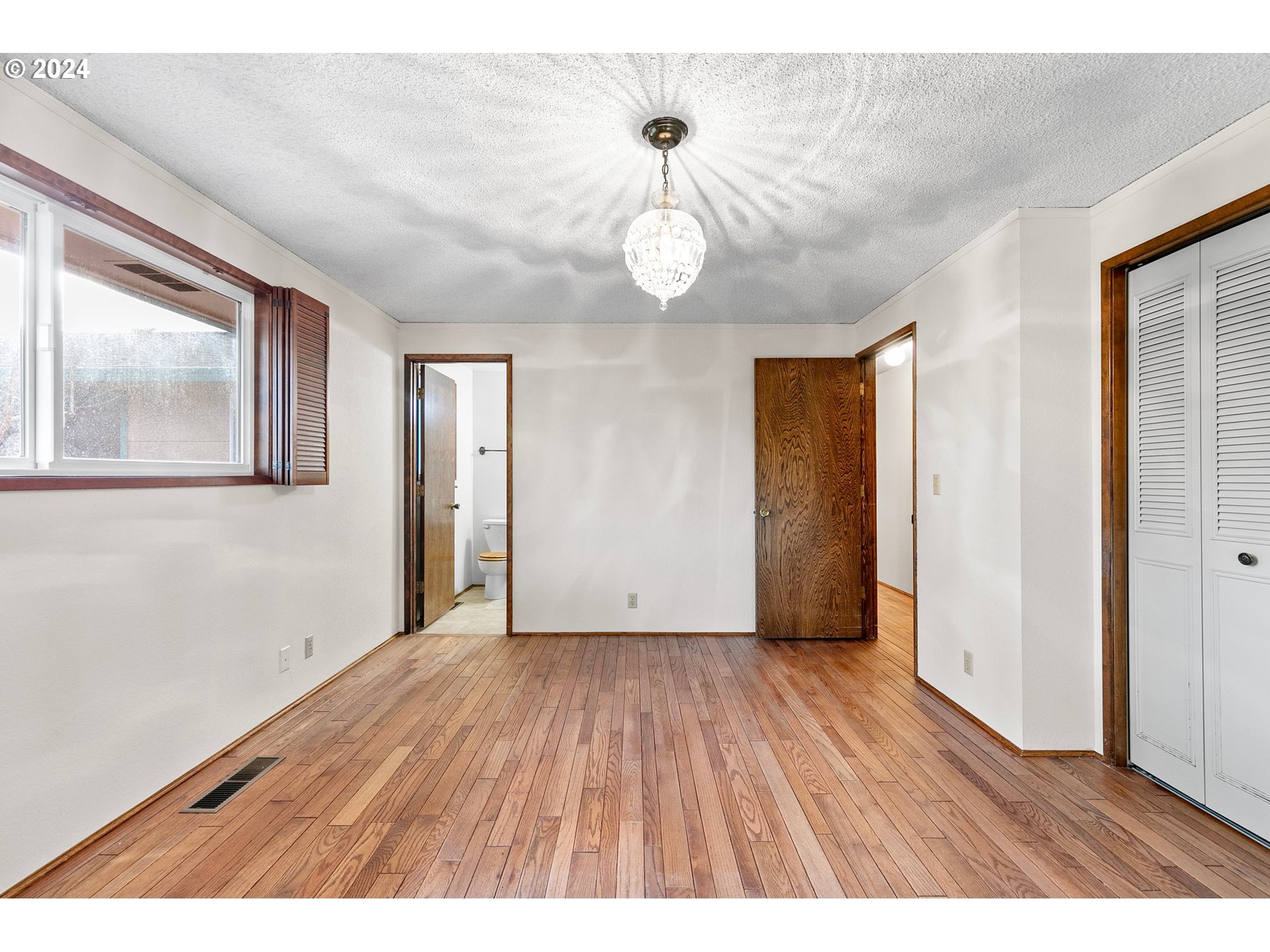 609 Rowan Avenue Springfield, OR 97477 - Photo 24 of 32 a view of an empty room with wooden floor and window