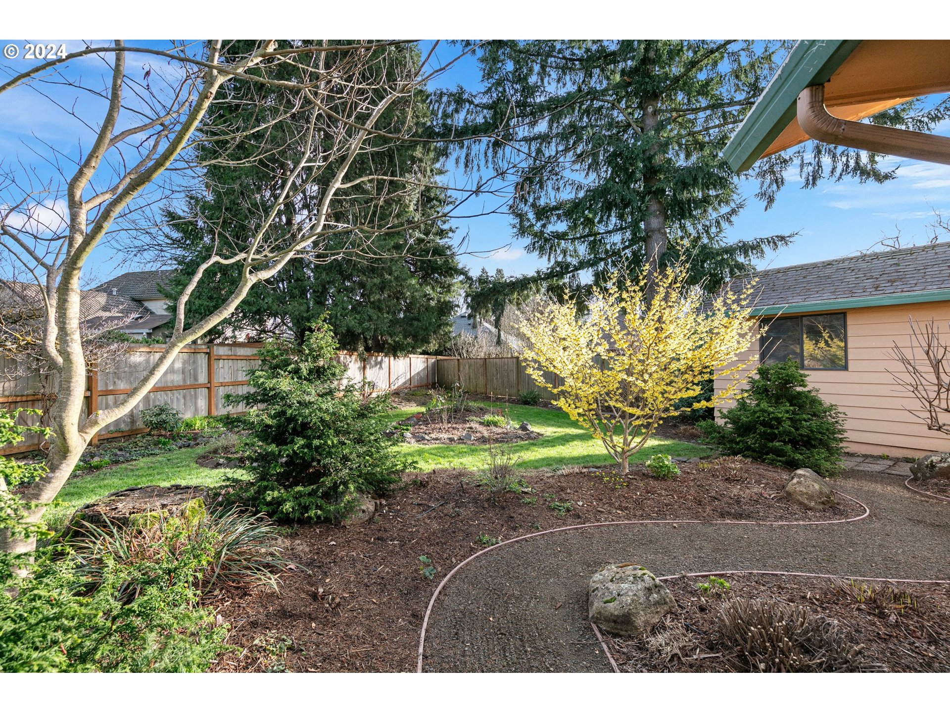 609 Rowan Avenue Springfield, OR 97477 - Photo 28 of 32 a backyard of a house with a yard and outdoor seating