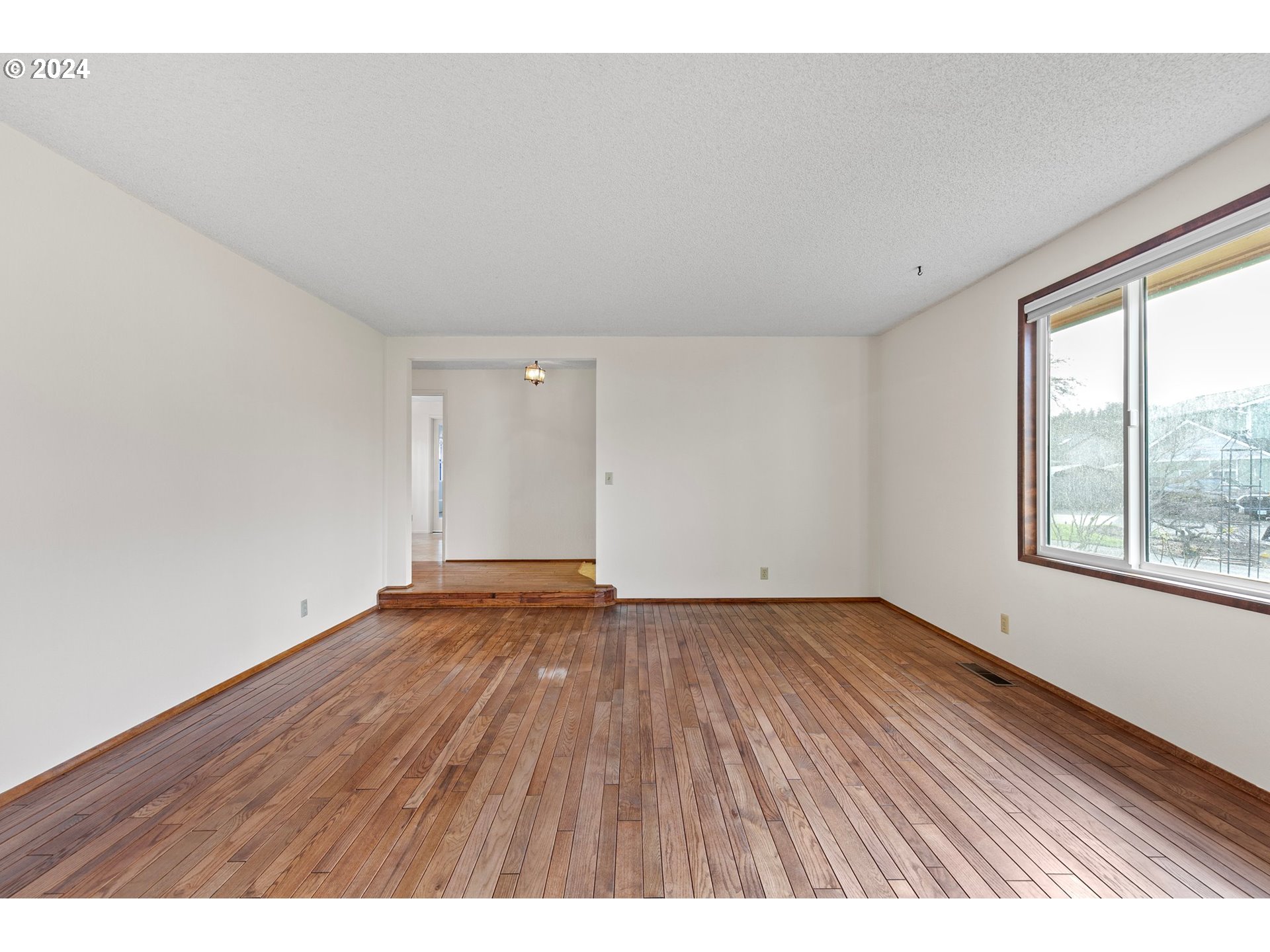 609 Rowan Avenue Springfield, OR 97477 - Photo 5 of 32 a view of an empty room and window