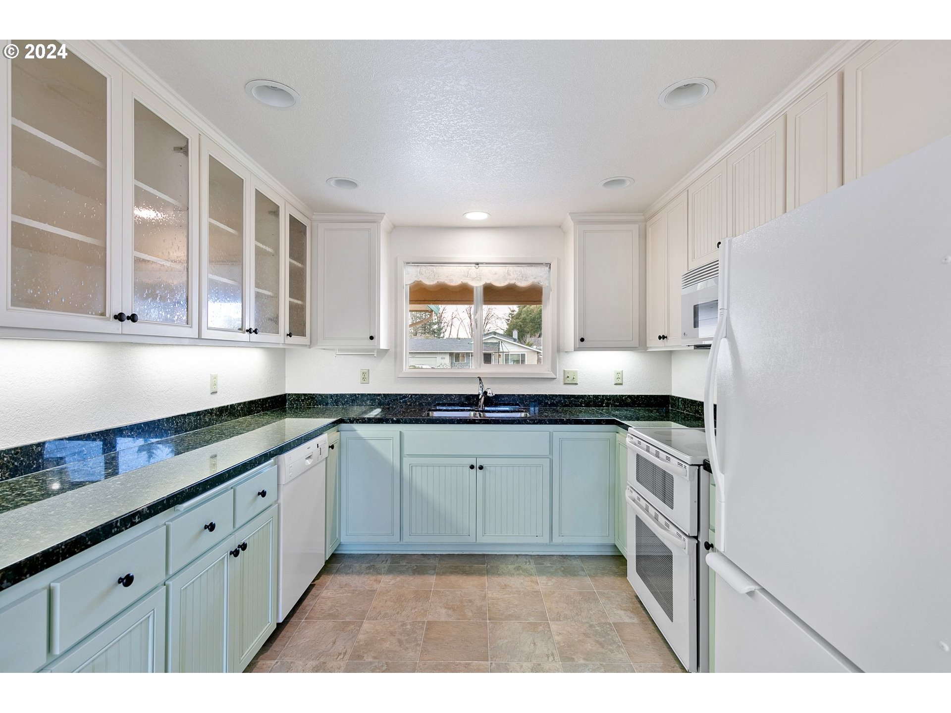 609 Rowan Avenue Springfield, OR 97477 - Photo 8 of 32 a kitchen with granite countertop a sink stainless steel appliances and cabinets