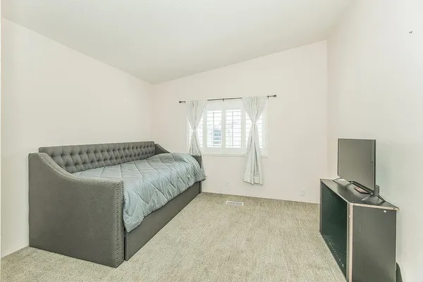 a bedroom with a bed and a view of bathroom