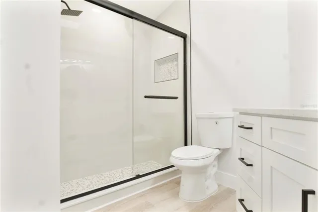a bathroom with a toilet and a shower