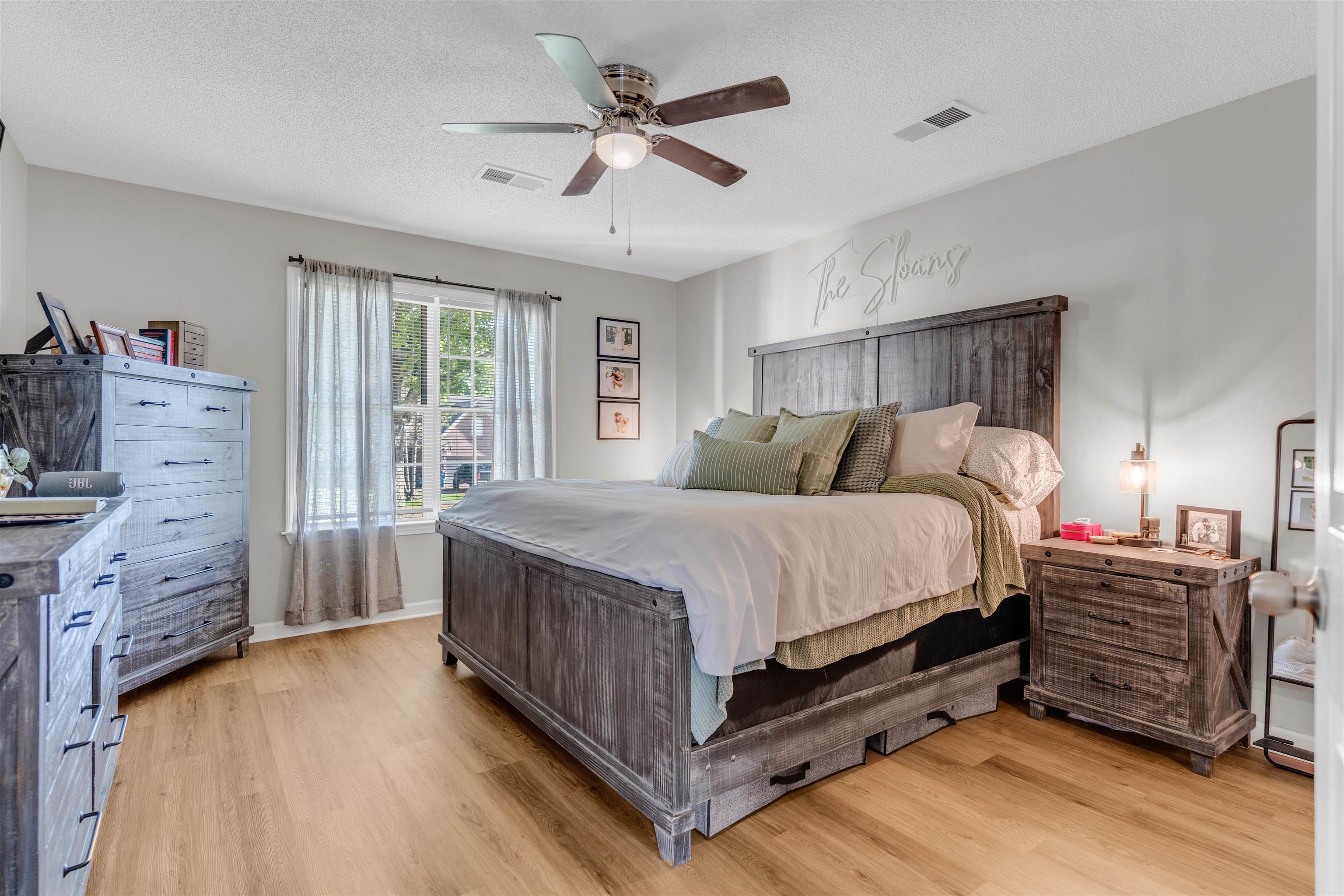 126 Buck Stand Road Atoka, TN 38004 - Photo 12 of 21 Bedroom featuring light wood-style floors, a ceiling fan, a textured ceiling, and baseboards