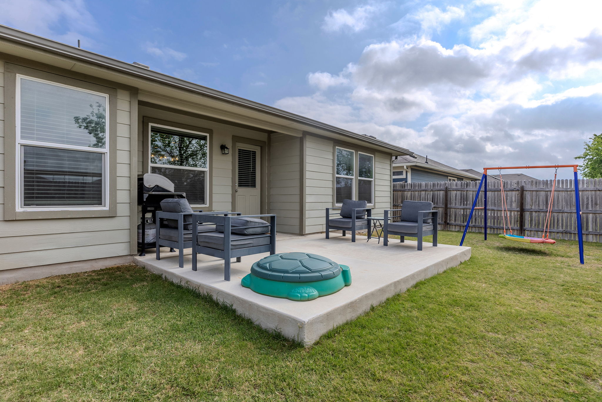 404 Cassandra Drive Hutto, TX 78634 - Photo 35 of 40 Fenced backyard with a patio area, a playground, and a trampoline
