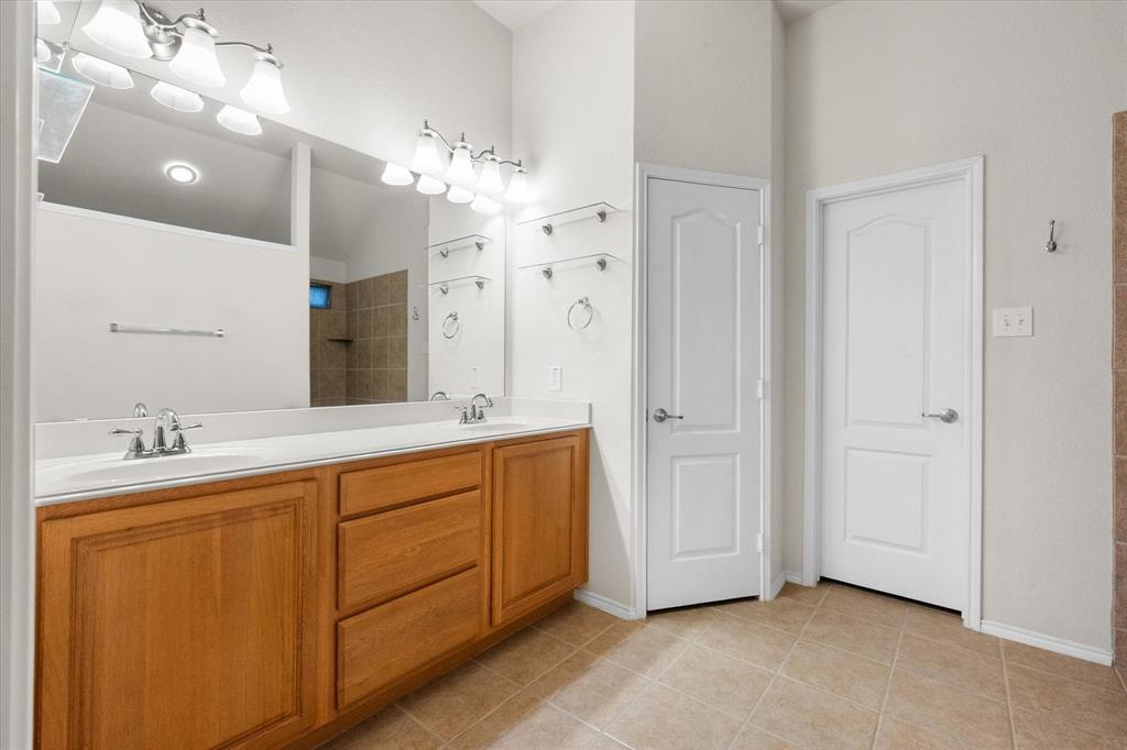 10929 Soft Shell Drive Venus, TX 76084 - Photo 12 of 39 a spacious bathroom with a double vanity sink mirror and shower