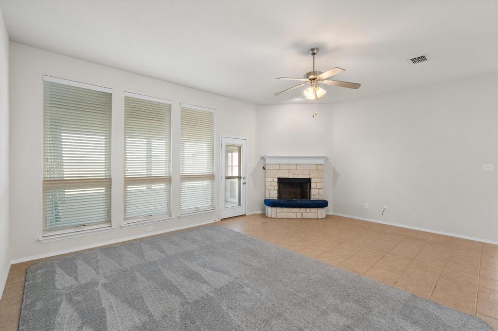 10929 Soft Shell Drive Venus, TX 76084 - Photo 14 of 39 an empty room with chandelier fan and windows
