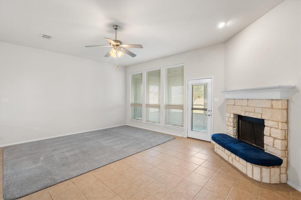 10929 Soft Shell Drive Venus, TX 76084 - Photo 15 of 39 an empty room with fireplace and fan