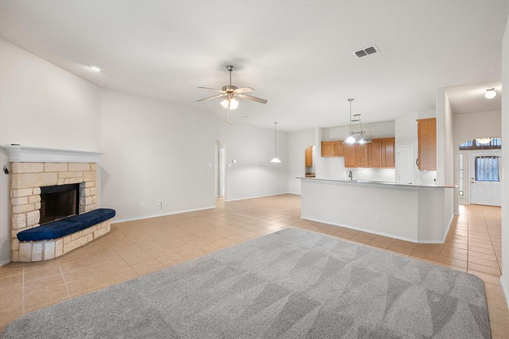10929 Soft Shell Drive Venus, TX 76084 - Photo 17 of 39 an empty room with kitchen and fireplace