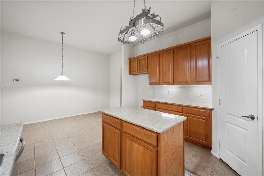 10929 Soft Shell Drive Venus, TX 76084 - Photo 25 of 39 a kitchen with stainless steel appliances granite countertop a sink a stove and a wooden floors