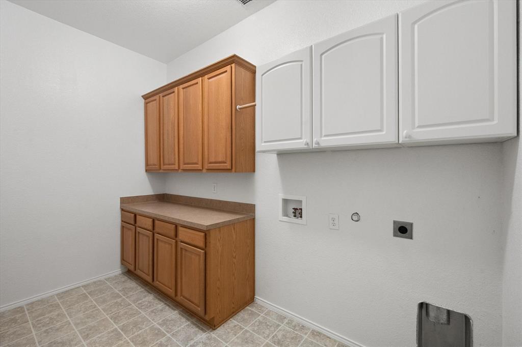 10929 Soft Shell Drive Venus, TX 76084 - Photo 32 of 39 a kitchen with stainless steel appliances granite countertop a stove a sink and a white cabinets