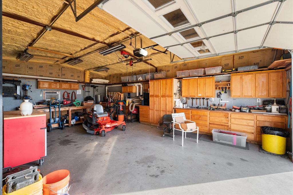 10929 Soft Shell Drive Venus, TX 76084 - Photo 39 of 39 a view of a garage with a table and chairs