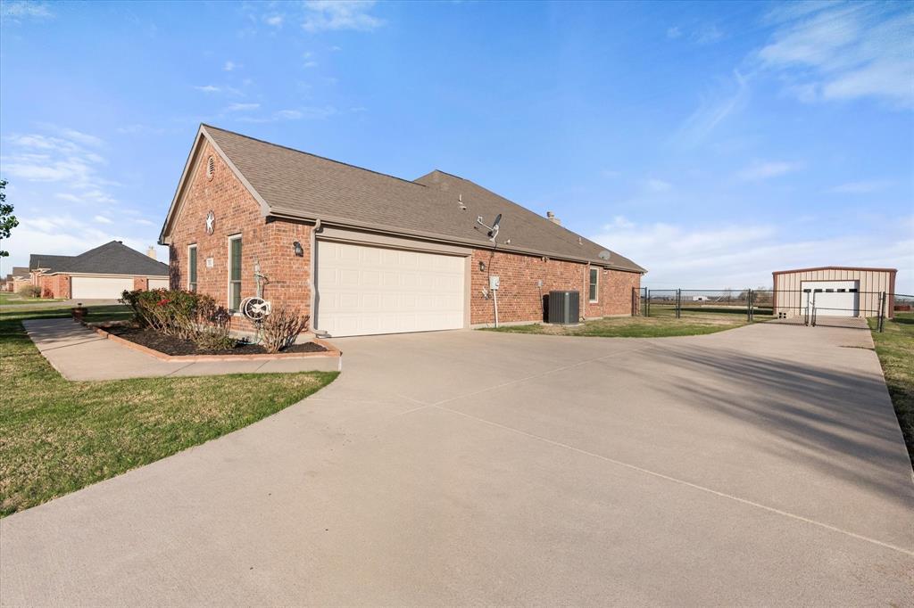 10929 Soft Shell Drive Venus, TX 76084 - Photo 4 of 39 a front view of a house with a yard and garage
