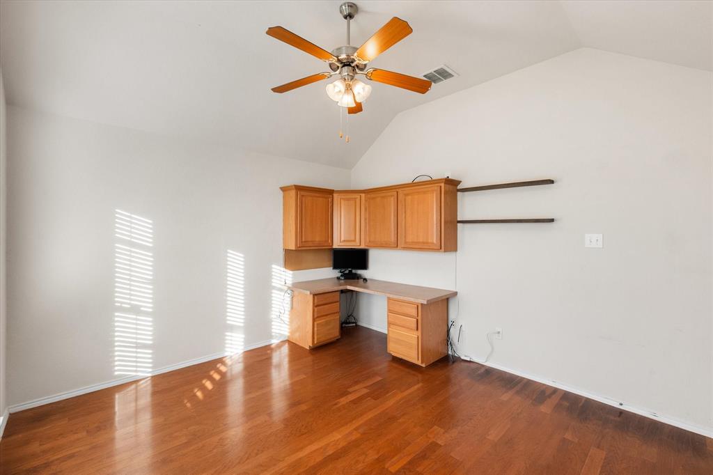 10929 Soft Shell Drive Venus, TX 76084 - Photo 5 of 39 a view of a kitchen with a sink cabinetry a chandelier and wooden floor